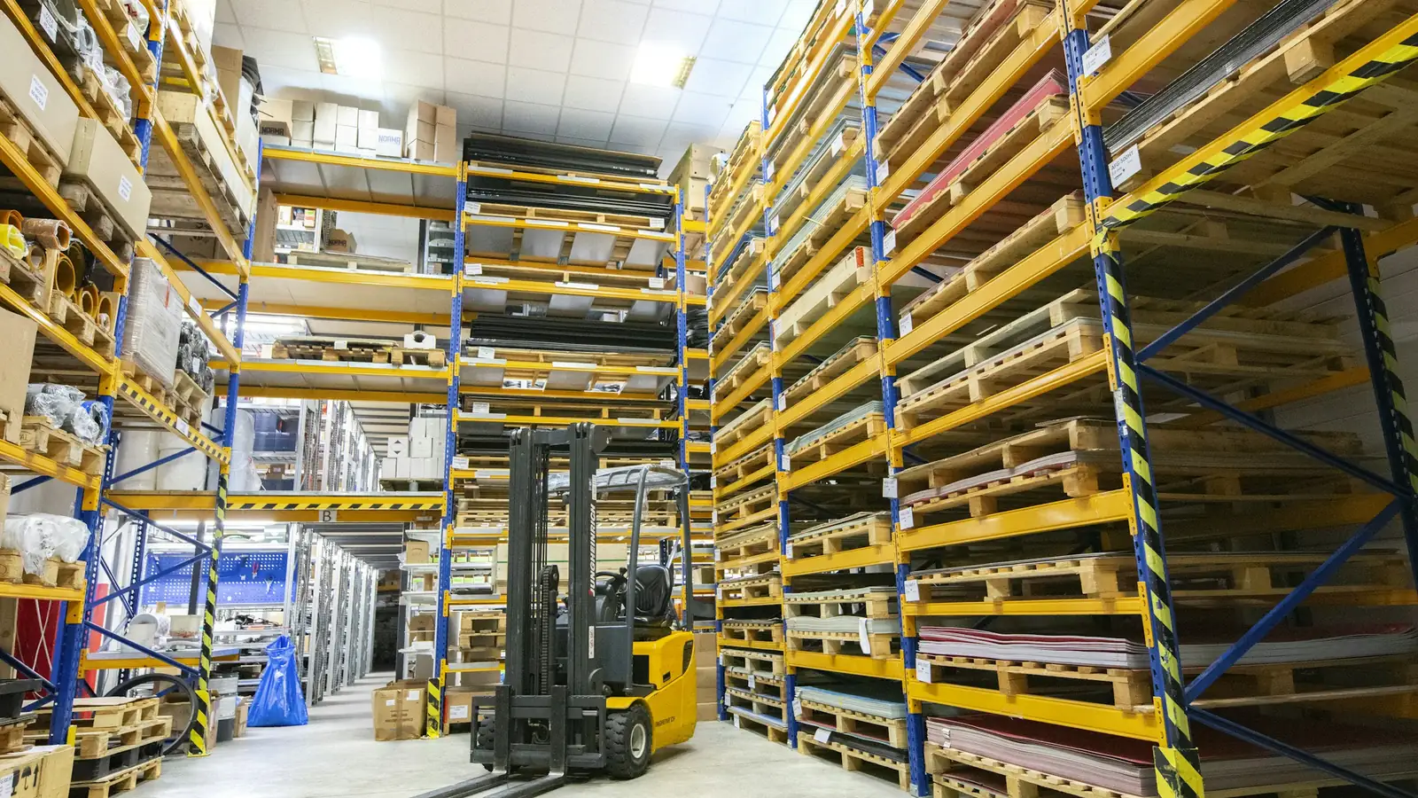 Warehouse aisles with stacked pallets, request a legal services proposal