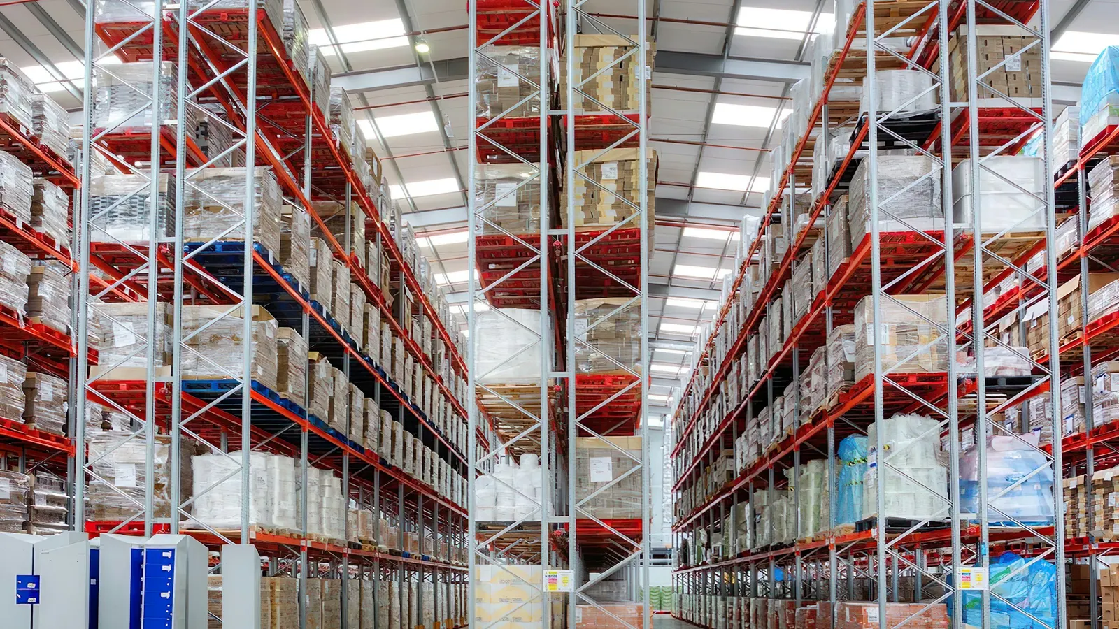Tall warehouse racking stocked with palletized goods, freezing a debtor's inventory in Mexico
